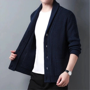 Detail of navy blue chunky knit cardigan featuring classic shawl collar and ribbed cuffs