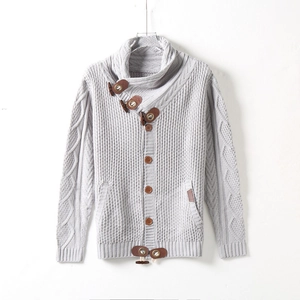 Detail of light grey cardigan featuring cable knit sleeves and brown leather neck strap