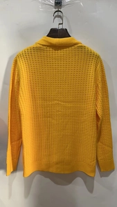 Detail of bright yellow waffle knit texture on a long sleeve cardigan sweater for men