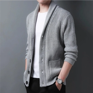 Close-up of grey knitted cardigan showing shawl collar, buttons and side pockets texture