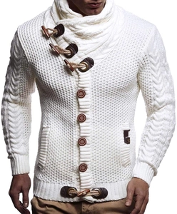 Detail of white knit cardigan showing cable knit texture and toggle button collar