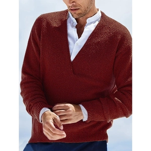 Detailed close-up of terracotta knit sweater featuring deep V-neck and waffle texture fabric