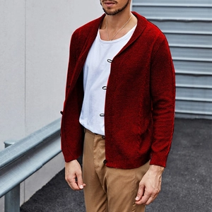 Detailed view of the dark red waffle knit texture and traditional button closure on the cardigan