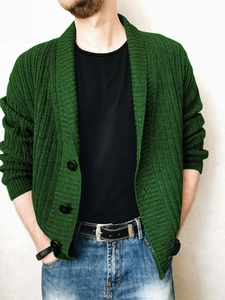 Close-up of men's dark green shawl collar cardigan with textured knit and large buttons