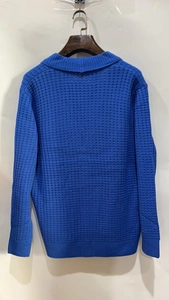 Detailed view of the waffle knit texture and ribbed cuffs on the blue men's cardigan