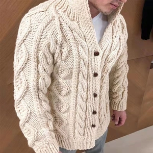 Close-up of beige heavy-knit men's cardigan featuring intricate cable knit and large buttons