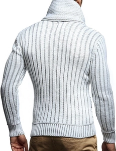Macro view of men's ribbed knit sweater with leather buckle and thick turtleneck collar