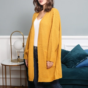 Close-up of bright yellow long sleeve waffle knit cardigan with side pocket detail