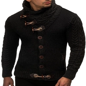 Close-up of black cable-knit wool cardigan showing wood toggle buttons and texture