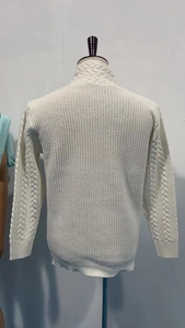 Macro view of white cable knit pattern and stand collar on men's winter sweater