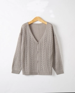 Detail of grey V-neck knit cardigan showing intricate openwork leaf crochet patterns