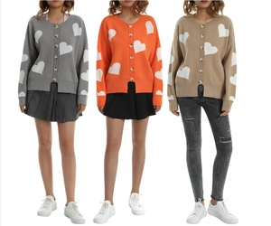 Detail view of heart pattern knit cardigan sweaters in grey orange and light brown colors