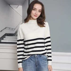 Close-up of gold buttons on the shoulder of striped knit sweater for women