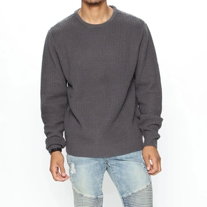 Detailed view of dark grey waffle knit sweater texture and ribbed crew neck for men