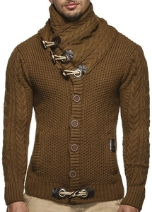 Detailed close-up of brown chunky knit cardigan featuring horn buttons and cable stitching