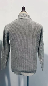Detail of grey cable knit pattern on back and collar of men sweater with thick texture