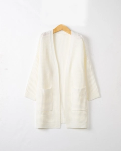 Detail view of white waffle knit cardigan texture and large front functional pockets