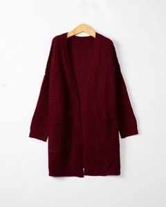 Close-up of deep wine red waffle knit texture and functional side pockets on long cardigan