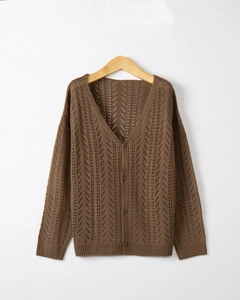 Detail shot of brown crochet knit cardigan with hollow v-neck and textured arrow patterns
