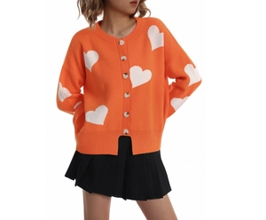 Detail of orange knit cardigan with white heart jacquard pattern and button closure