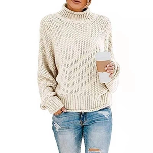 Dettagli di un maglione a collo alto in maglia spessa color crema con bordi a coste