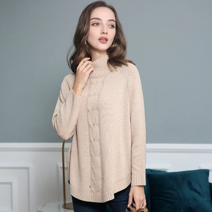 Detail of high collar knit sweater showing intricate cable stitch and apricot texture