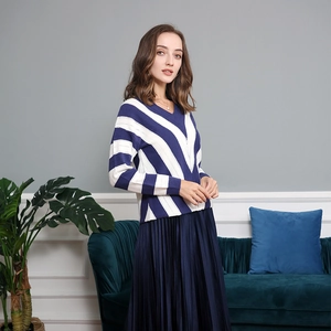 Detail of blue and white striped knit sweater with V-neckline and elegant texture