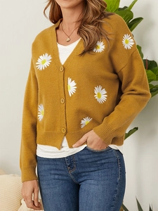Detail of daisy embroidery on mustard yellow knit cardigan with matching buttons