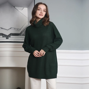 Detail view of a dark green high-neck knitted sweater with a loose medium-length fit