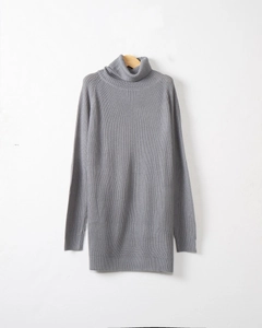 Vertical view of grey turtleneck knit sweater on a wooden hanger against a clean wall