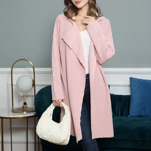 Detail of soft pink long knit cardigan featuring vertical ribbed texture and loose lapels