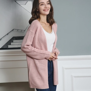 Detail showing soft pink chunky knit texture and ribbed cuffs of this loose long cardigan