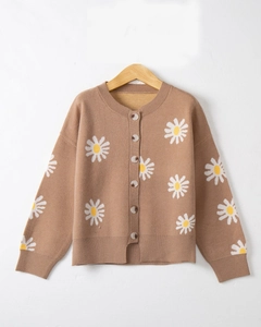 Detail of brown knitted cardigan featuring white daisy embroidery and button-down front