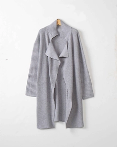 Detail of light grey chunky knit cardigan featuring a large lapel and loose casual fit