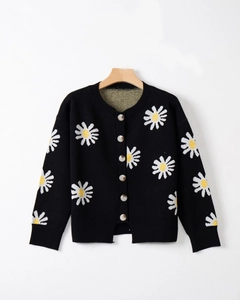 Close-up of black V-neck cardigan with daisy embroidery and grey buttons detail