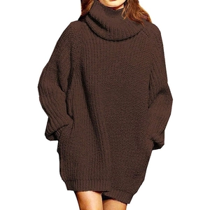 Close-up of chunky knit texture and turtle neck on the oversized brown sweater dress