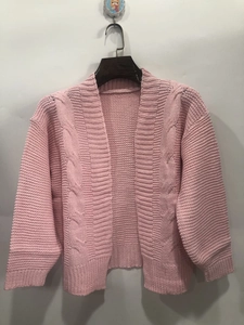 Close-up detail of pink cable knit texture on a long sleeve open front cardigan sweater