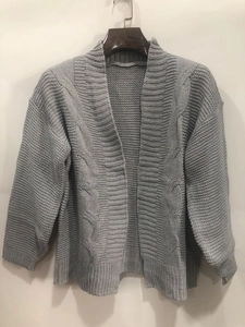 Detail of grey cable knit cardigan showing thick texture and striped pattern on the fabric
