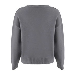 Detail view of grey knit sweater back showing ribbed cuffs and fine stitching texture