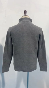 Close-up back view of grey waffle knit cardigan showing thick textured fabric and high collar