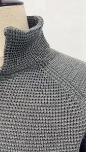 Detail of gray men's knit cardigan showing waffle texture and stand collar construction