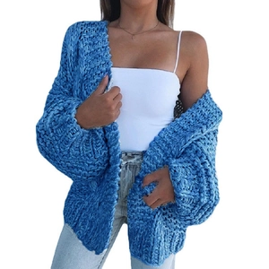 Close-up of blue chunky knit cardigan featuring thick texture and loose drop-shoulder design
