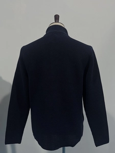Detailed back view of dark blue waffle knit cardigan featuring a textured stand collar
