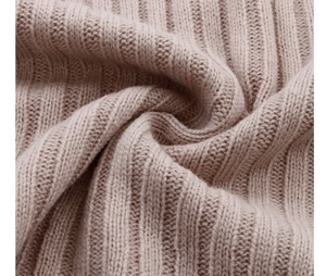 Close-up detail of soft ribbed knit fabric on a long sleeve warm sweater dress