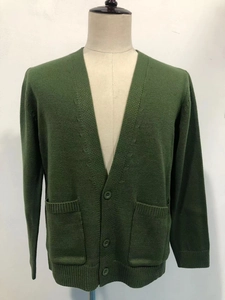Detail of dark green knitted cardigan for men featuring a V-neck and classic button closure