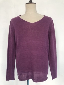 Detail of purple long-sleeved V-neck knit sweater showing texture and loose fit style