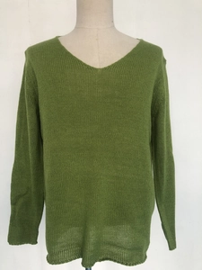 Close-up of grass green men's V-neck knit sweater with premium ribbed texture and cuffs