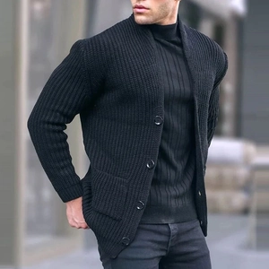Close-up of men's chunky knit cardigan featuring textured fabric, shawl collar, and buttons