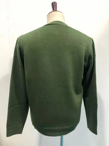 Detail view of the ribbed cuffs and hem on this army green knit cardigan sweater for men