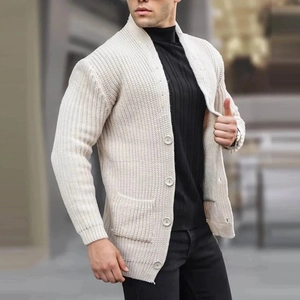 Men's cream shawl collar knit cardigan with buttons and front pockets in outdoor street setting